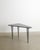 A rare and contemporary "45 degrees north latitude" tripod console table with a black and white decorative marble top on...