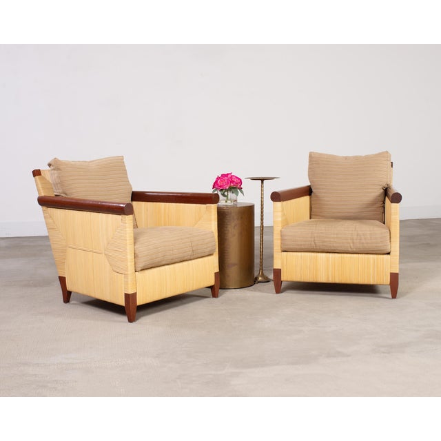 Impressive pair of oversized rattan lounge or club chairs designed by John Hutton for Donghia in the late 20th century....