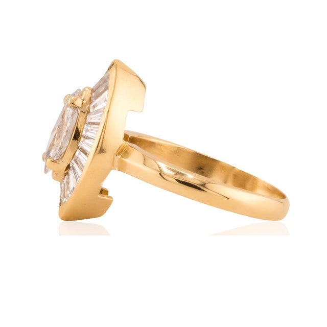 18k Ring rith GIA 0.76 carat E color SI2 clarity Marquis cut diamond and 18 tapered baguette cut diamonds weighing...