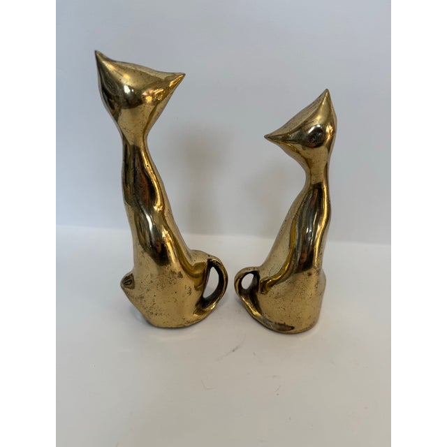 Add a touch of Mid-Century sophistication to your décor with this charming pair of stylized brass cat figurines. Featuring...