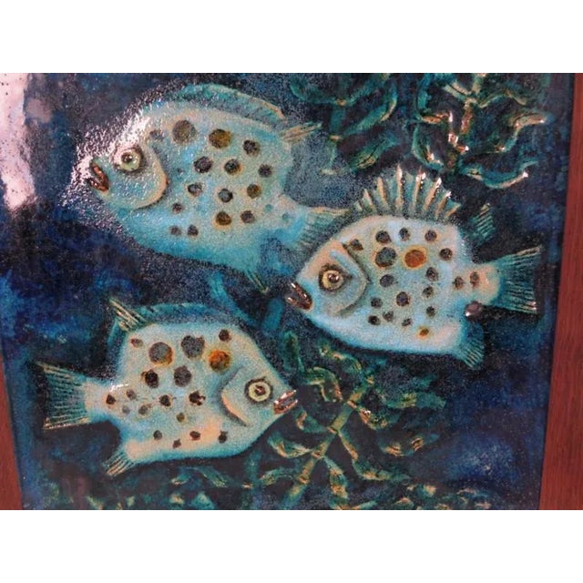 This large ceramic wall plate featuring fish is in relief-form and was produced by Karlsruher Majolika. The backside bears...