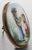 Antique 9K Yellow Gold Oval Hand-Painted Porcelain Brooch, depicting two young maidens in period clothing surrounded by...
