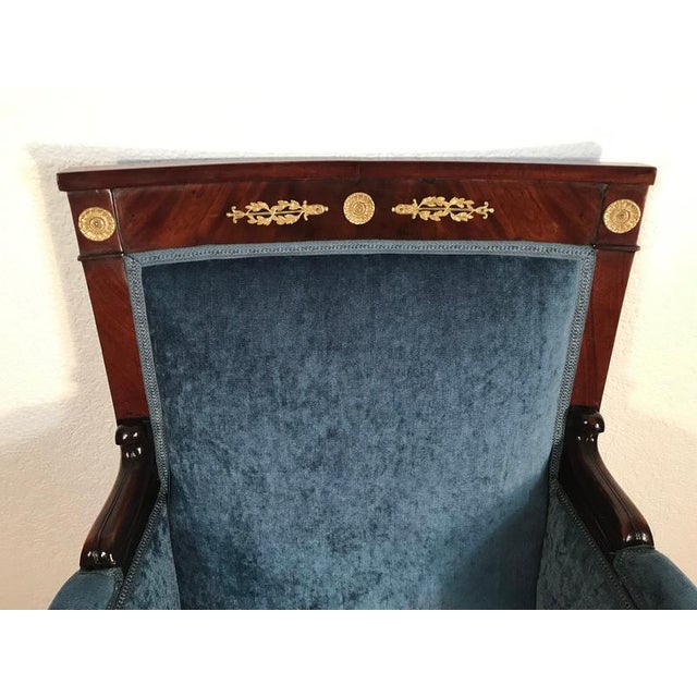 This elegant Empire mahogany bergère, dating to the early 19th century, combines a strong architectural silhouette with...
