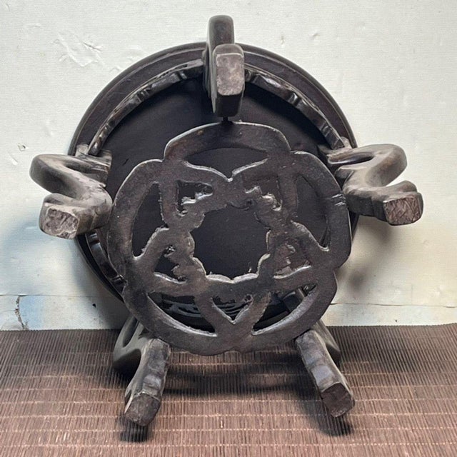 Elevate your decor with this elegant vintage Chinese carved wooden display stand. Crafted from dark, richly grained...