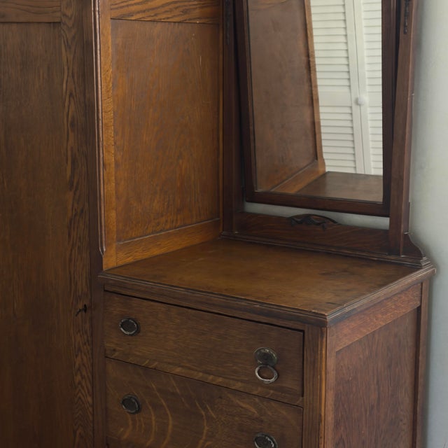 Antique oak wood gentleman’s chest or chifferobe with adjustable mirror and pull out clothes rack. Dovetailed drawers,...