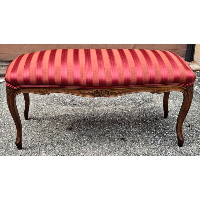 A Mid Century Provincial Carved Walnut and Cranberry Stripe Upholstered Bench. Recently reupholstered. Great vintage...