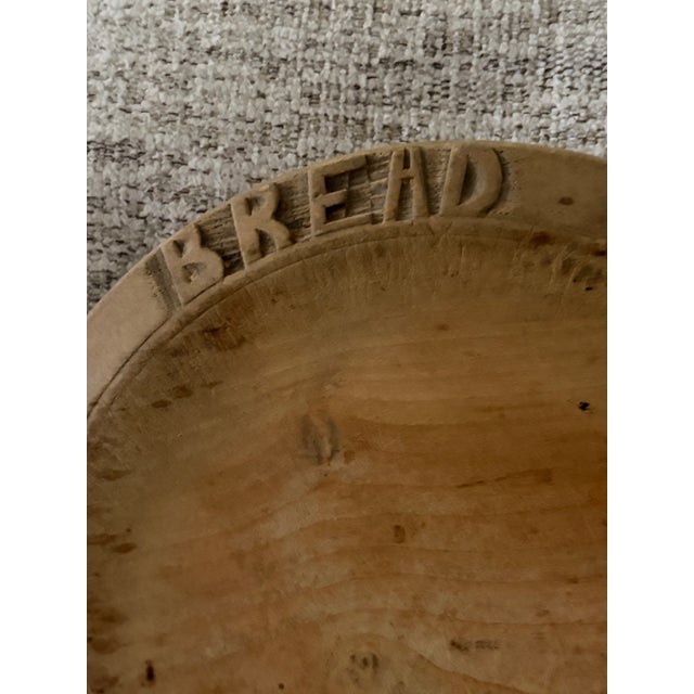 Pine colored English bread board with wheat design carvings and the word “Bread” carved at the top