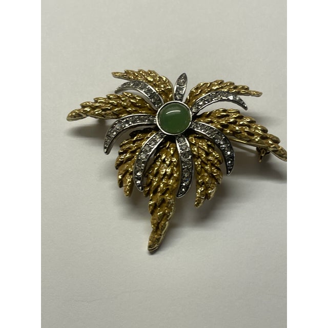 Stunning gold earing and pin set with jade center and cz's thru out flower cluster burst.Old world elegance