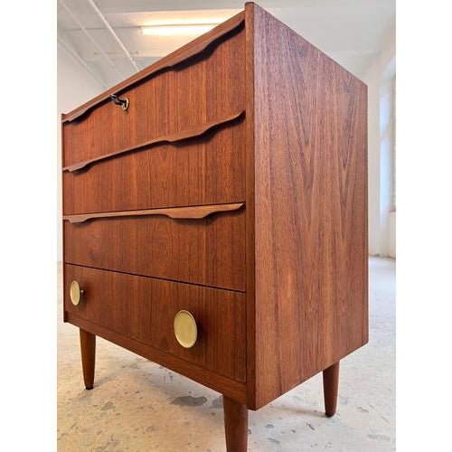 This Danish chest of drawers, crafted from high-quality teak, is a characterful piece of furniture that captivates with...
