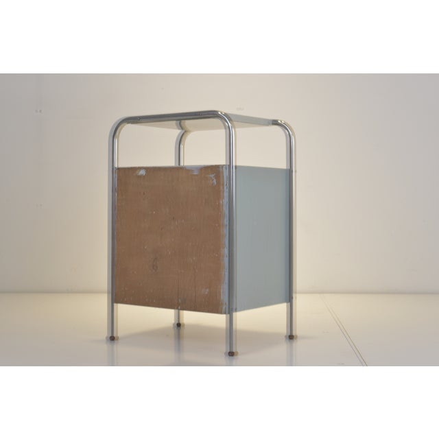 In the modernistic BAUHAUS Style designed shows the nightstand its minimalistic Beauty. On the top shelf and all around...