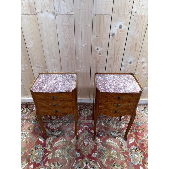 A charming pair of Louis XV style bedside tables. These two small bedroom pieces are distinguished by their meticulous...