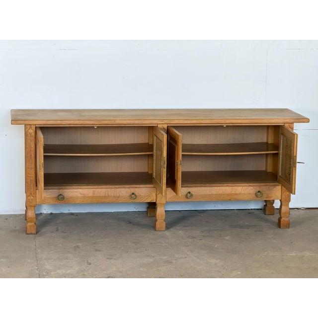 Danish sideboard in solid oak with a bleached, limed finish, produced by an unknown Danish cabinetmaker, circa 1960s. The...