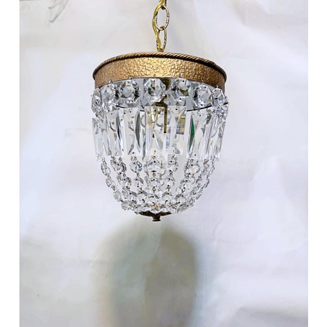 A beautiful fusion of classic European elegance and Art Deco-inspired glamour, this vintage crystal chandelier is a...