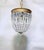 A beautiful fusion of classic European elegance and Art Deco-inspired glamour, this vintage crystal chandelier is a...