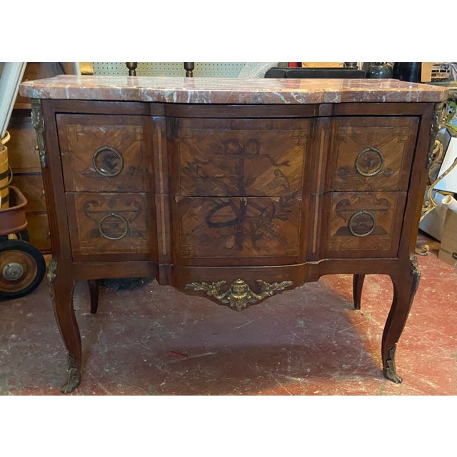 Late 18th Century to mid 19th Century French marquetry inlaid commode with what’s thought to be a Rosa Girona marble top....