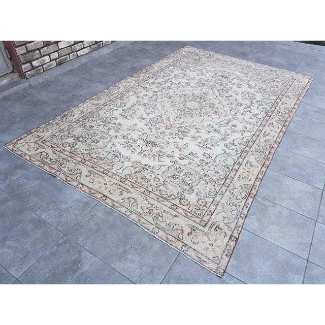 This is a vintage Turkish Oushak rug from the 1960s. The piece was hand-knotted