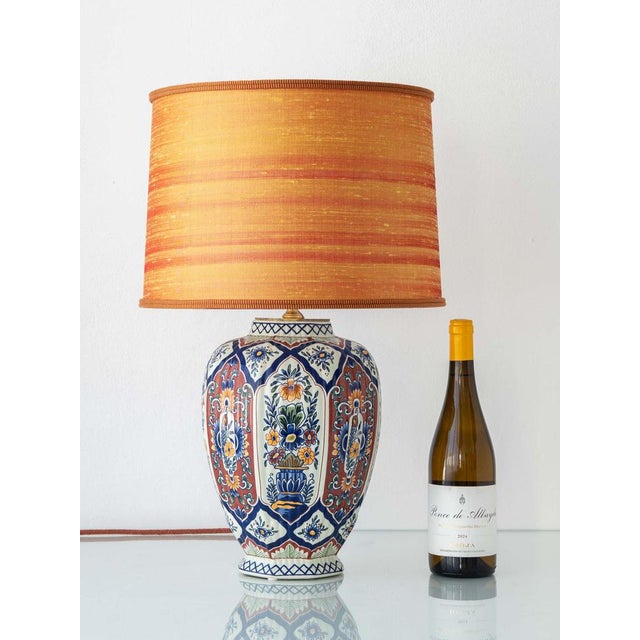 Royal boch (boch frères), belgium, mid-20th century. table lamp crafted from a vintage boch “handworked” delft-style...