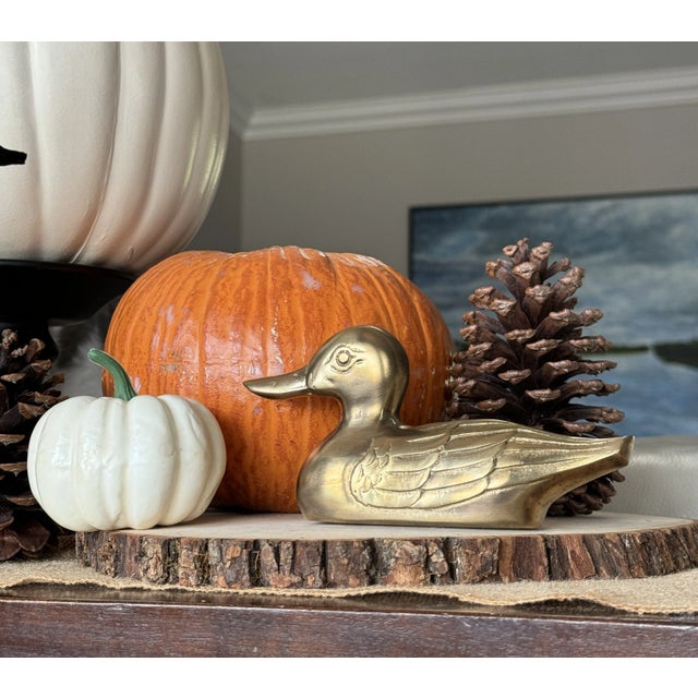 Add a touch of timeless elegance to your home with this exquisite Brass Duck. It is meticulously crafted from solid brass...