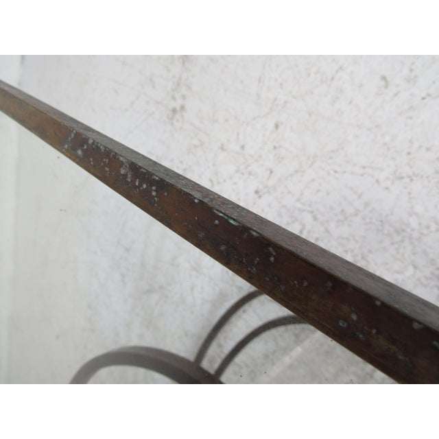 An elegant Mid-Century Modern coffee table designed in the style of Charles Hollis Jones. A unique base with swirling...