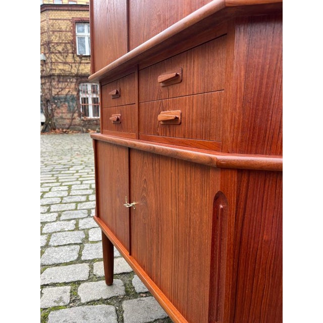 This teak corner cabinet from Aulum Møbelfabrik in Denmark offers ample storage in a compact space and is a true mid-...