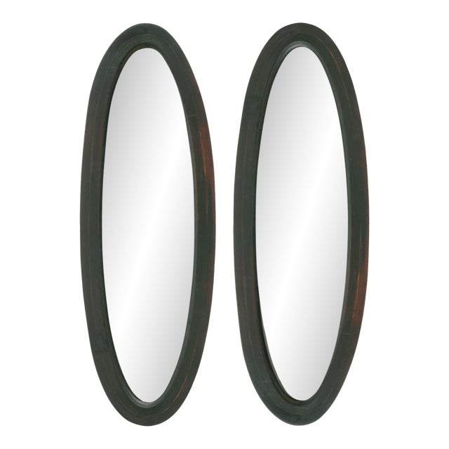 1940s Slender Ebonized Mahogany Oval Mirrors; A Pair For Sale