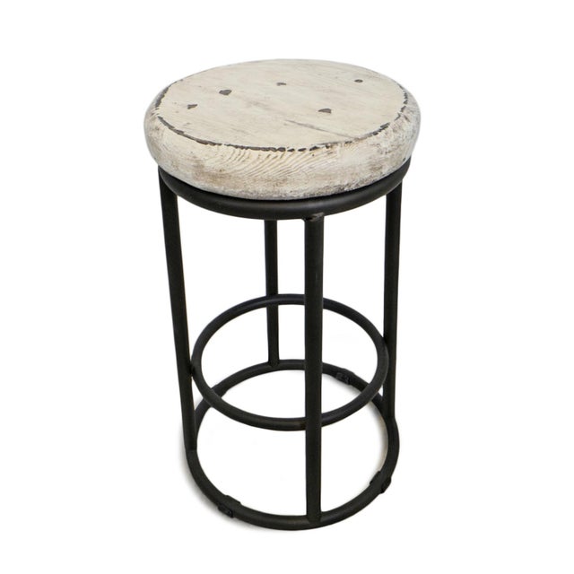 Round black iron base counter stool with distressed painted white salvaged wood top. Each slightly wonderfully unique in...