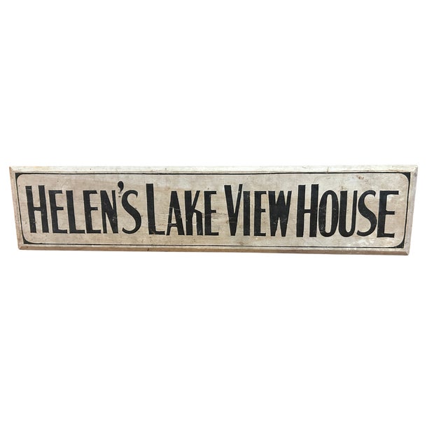 Long one sided wooden sign reading "HELEN'S LAKE VIEW HOUSE". Sign is painted white with black letters and dates to...