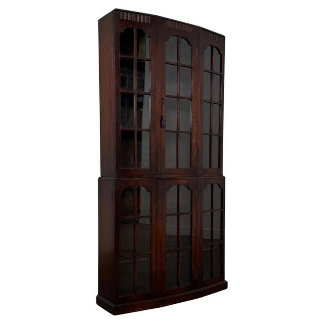 A handsome early 20th-century English display cabinet, finely crafted from oak and distinguished by its extensive glazing,...