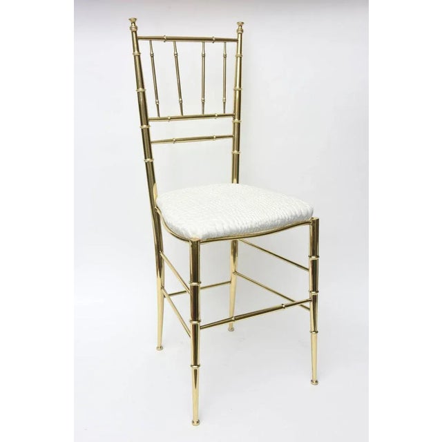 This lovely restored and polished brass Italian midcentury Chiavari side chair has faux bamboo elements. It has been just...