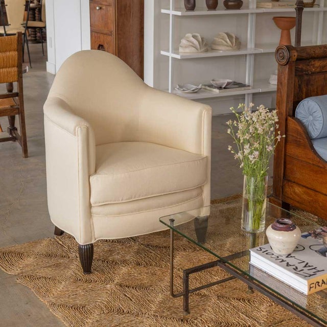 Lovely pair of Art Deco club chairs from France, 1930s. Beautiful curved wood frame with carved detail on feet. Newly...
