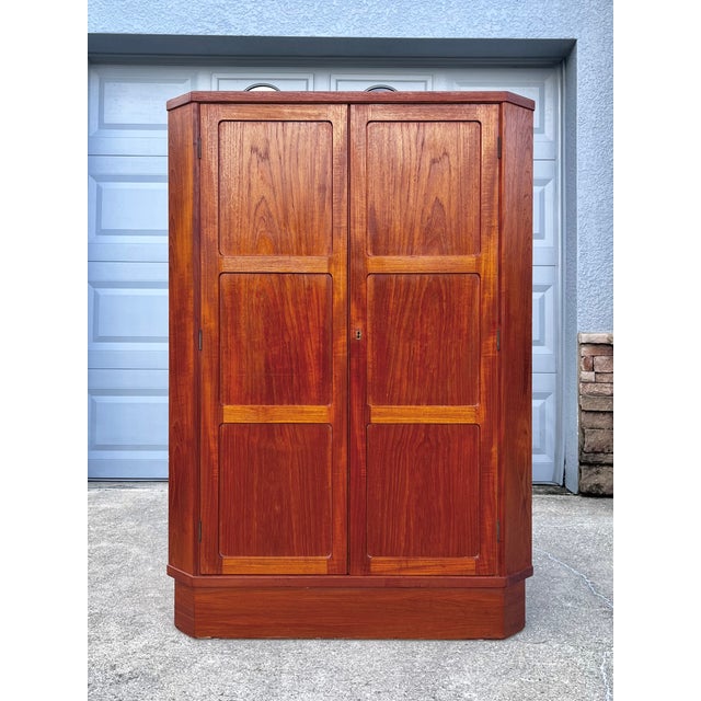 Mid-century teak corner cabinet with lock and key by Vamo Sønderborg Møbelfabrik. A rare find! This corner cabinet...