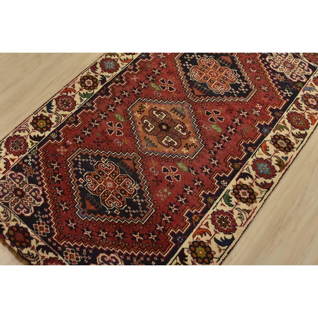 An authentic vintage tribal Qashqai rug hand-knotted with fine wool and natural dyes. This nomadic rug features geometric...