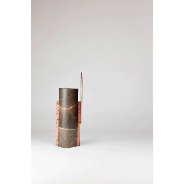 In Archetico, stone and reflection meet in an essential synthesis. The mirrored circle emerges from the marble as a primal...