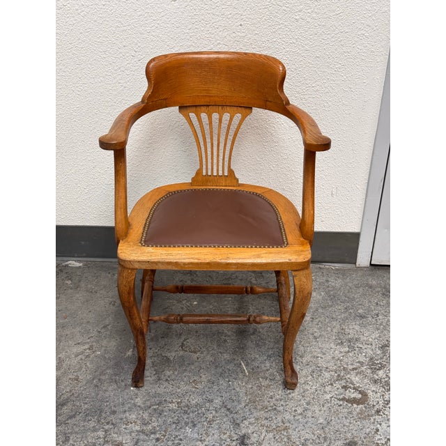 Design Plus Gallery presents an Antique Oak Captain’s Chair. This antique oak chair has a curved crest rail, shaped open...