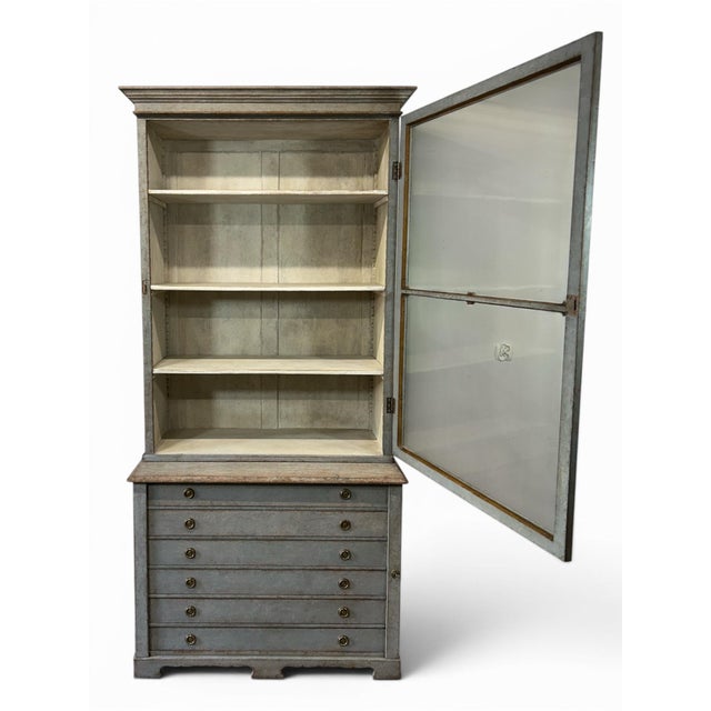 A unique Swedish glass display case in grey. The piece consists of two stacked sections. The upper section has a single...