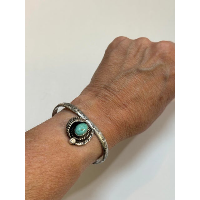 A striking vintage southwest Navajo style cuff bracelet, expertly handcrafted in sterling silver. The focal point of this...