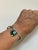 A striking vintage southwest Navajo style cuff bracelet, expertly handcrafted in sterling silver. The focal point of this...