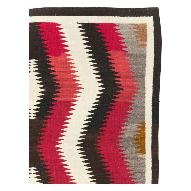 A vintage American flatweave square accent rug handmade by the Navajo tribe during the mid-20th century. Measures: 4' 8" x...