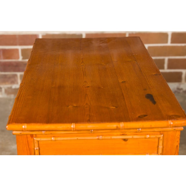 An English pine faux bamboo desk with two drawers and cross stretcher. Introduce a touch of rustic charm and timeless...