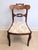 This gorgeous mahogany parlor chair features a "hoop" or "balloon" back with a prominent curved crest rail that is carved...