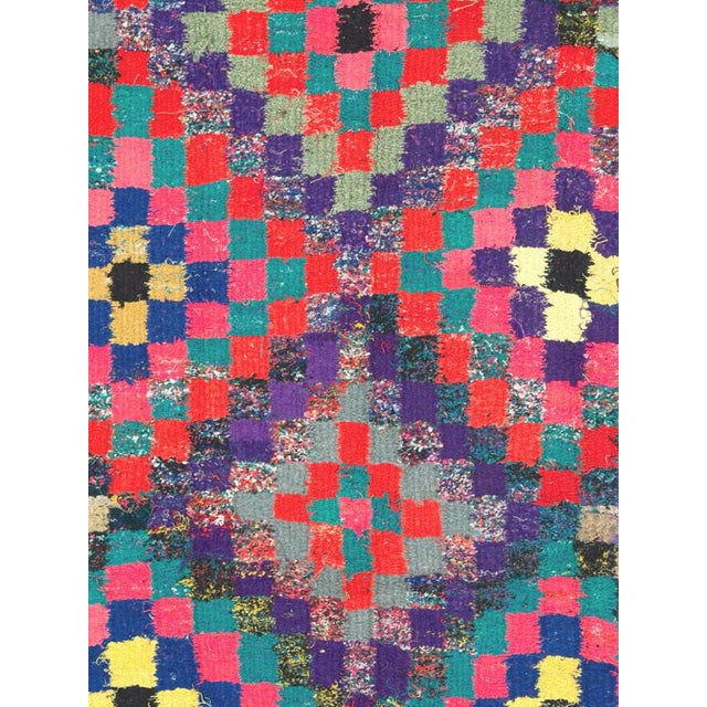A vibrant Mid-20th century Persian flatweave kilim distinguished by its exuberant checkerboard composition and bold...