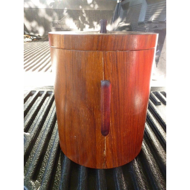 This is a vintage mid-century modern ice bucket. The piece is made of rosewood and features a sharp stylized design. This...