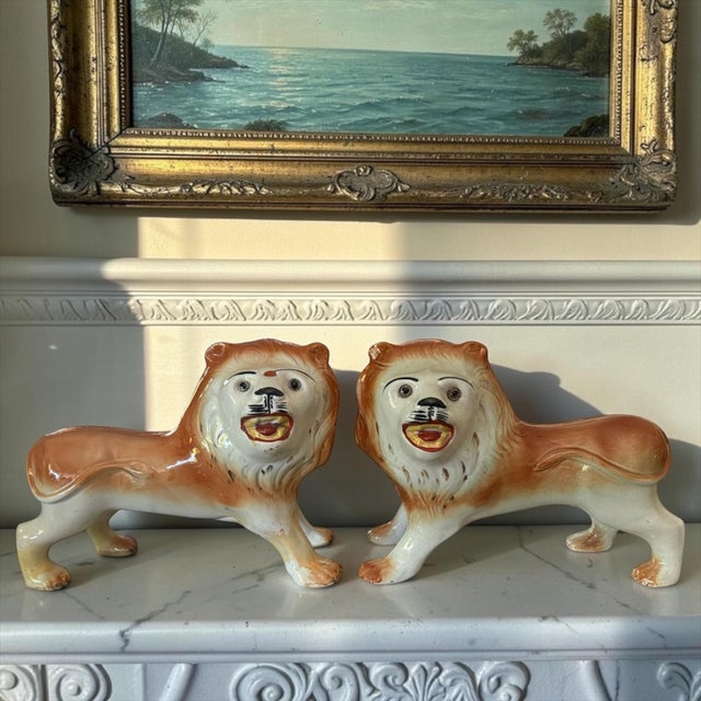 A wonderfully expressive pair of large antique Staffordshire pottery lions, English, dating to the late 19th century,...