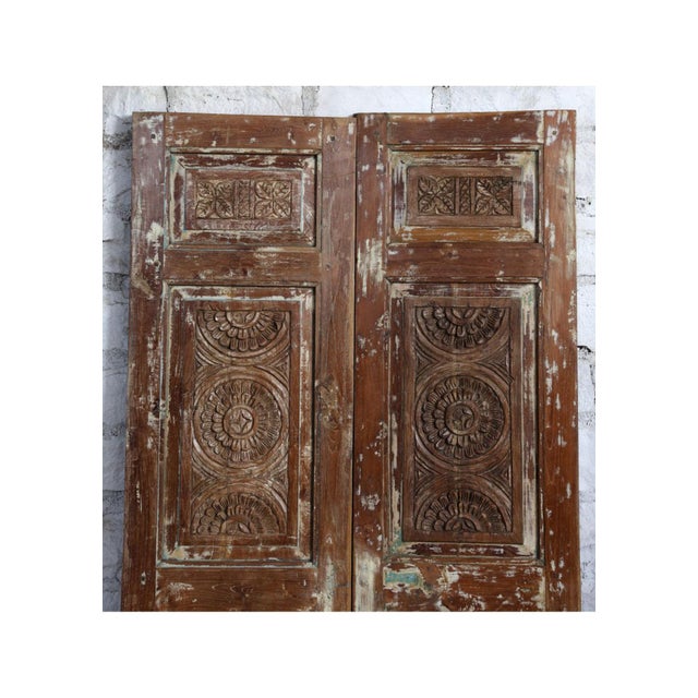 Showcasing exceptional craftsmanship and old-world charm, this antique Indian double door is meticulously hand-carved from...