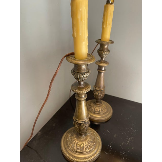 Pair of Bronze Candlesticks Adapted as Lamps, 19th Century. Includes hand-painted lamp shades