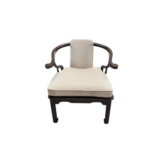 Elegant armchairs featuring beautifully curved, dark wood frames and sculptural wraparound arms. Each chair has been...