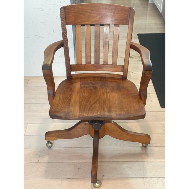Beautiful, structurally pristine antique bankers desk chair dating from the early 20th century (circa 1910–1930). Crafted...