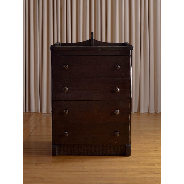 A richly detailed antique chest of drawers featuring a beautifully carved horse motif and a deeply textured wood finish....