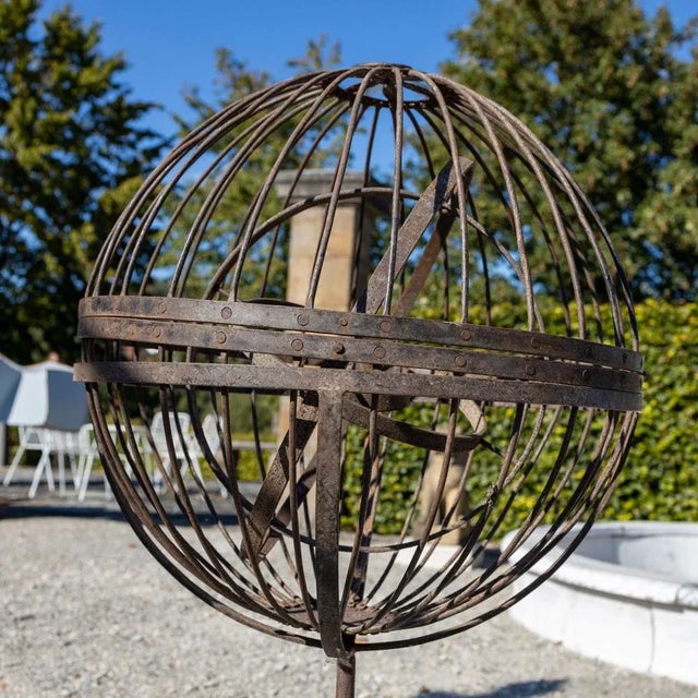 Pair of spherical iron ship lanterns on a tripod stand.