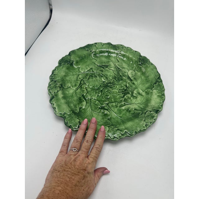 This is a large Italian ceramic serving platter shaped and glazed to resemble overlapping oak leaves, a stunning example...